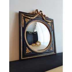 Miroir de sorcière dans cadre noir et détails or style empire