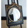 Miroir de sorcière dans cadre noir et détails or style empire